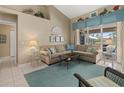 Inviting living room with comfortable seating, stylish decor, and sliding glass doors to the outdoors at 555 Park Estates Sq, Venice, FL 34293