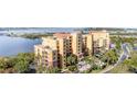 Condo building with balconies and palm trees, showcasing the coastal lifestyle at 615 Riviera Dunes Way # 208, Palmetto, FL 34221