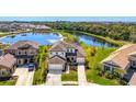 Stunning two-story home boasts lake views, manicured lawn, and a three-car garage in a desirable neighborhood at 9487 Tequila Sunrise Dr, Sarasota, FL 34241