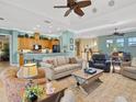 Open-concept living room and kitchen with a ceiling fan, breakfast bar, and recessed lighting at 12518 Harbour Landings Dr, Cortez, FL 34215