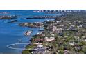 Panoramic aerial view of waterfront homes with boat docks along the scenic shoreline at 1440 Kimlira Ln, Sarasota, FL 34231