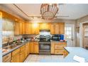 Kitchen featuring wooden cabinets, stainless steel appliances, and ample counter space at 1638 Banyan Dr, Venice, FL 34293