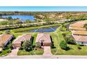 Beautiful home with lake view, lush landscaping, and tile roof in a desirable community at 167 Wandering Wetlands Cir, Bradenton, FL 34212