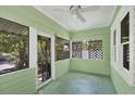 Enclosed front porch with windows and unique lattice details, perfect for relaxing at 1679 Arlington St, Sarasota, FL 34239