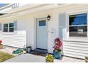 Charming home's front door with light blue paint, decorative plants, and stylish accents at 1827 Nevada Ne Ave, St Petersburg, FL 33703
