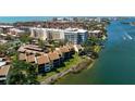 Aerial view showcasing waterfront condos, offering picturesque water views, and proximity to amenities at 1900 Cove Ii Pl # 133, Sarasota, FL 34242