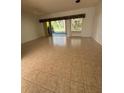 Spacious living room featuring tile flooring, a ceiling fan, and sliding glass doors to bring in natural light at 2097 Wasatch Dr, Sarasota, FL 34235