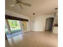 Open-concept living space with tile flooring, modern lighting, and views into the kitchen and entryway at 2097 Wasatch Dr, Sarasota, FL 34235
