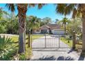 Charming home framed by palm trees and a gated entrance, providing privacy and a welcoming atmosphere at 2301 Bern Creek Loop, Sarasota, FL 34240