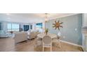 Bright dining area with modern furnishings, hard wood floors, and a view of the ocean at 420 Beach Rd # 502, Sarasota, FL 34242