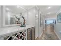 Tastefully decorated hallway with wine storage, bar area, and a view of the ocean at 420 Beach Rd # 502, Sarasota, FL 34242