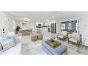 Bright, open living space featuring modern furnishings and a seamless flow into the kitchen and dining areas at 502 69Th St, Holmes Beach, FL 34217
