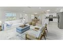 Bright, open living space featuring modern furnishings and a seamless flow into the kitchen and dining areas at 502 69Th St, Holmes Beach, FL 34217