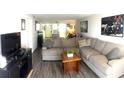 Spacious living room with wood floors and comfortable sectional sofa with decorative pillows at 507 Parkdale Mews # 507, Venice, FL 34285