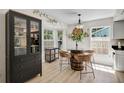 Bright kitchen featuring an eat-in table with barrel style stand, hardwood floors, and modern decor at 5611 22Nd E St, Bradenton, FL 34203