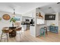 Inviting eat-in kitchen with stainless steel appliances, granite countertops, and a unique barrel table at 5611 22Nd E St, Bradenton, FL 34203