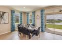 The spacious dining room with large windows offers an abundance of natural light and views of the backyard at 5627 Silver Moonlight Dr, Palmetto, FL 34221