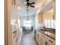 Bright kitchen featuring stainless steel appliances, granite countertops, and tiled floors at 5633 Sheffield Greene Cir # 40, Sarasota, FL 34235