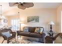 Inviting living room features a comfortable couch and beautiful nature-themed art at 5633 Sheffield Greene Cir # 40, Sarasota, FL 34235