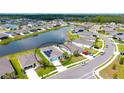 Beautiful aerial view of the home with solar panels, overlooking the water, and a well manicured landscape at 6105 114Th E Dr, Parrish, FL 34219