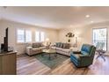 Inviting living room with wood floors, plush seating, and bright, shuttered windows at 700 Golden Beach Blvd # 222, Venice, FL 34285