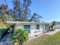 Well maintained single-story home with tropical landscaping and covered side porch at 240 Pocono E Trl, Nokomis, FL 34275