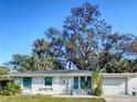 Charming single-story home boasts a well-maintained lawn and attached one-car garage at 240 Pocono E Trl, Nokomis, FL 34275
