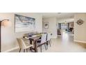 Open dining room with stylish decor open to living areas and kitchen at 10729 Hidden Banks Gln, Parrish, FL 34219