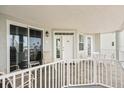 Balcony seating area with table and chairs, railing view of palm trees and buildings at 1260 Dolphin Bay Way # 404, Sarasota, FL 34242