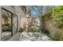 Private back patio area surrounded by lush greenery, providing a peaceful outdoor space at 1610 Treehouse Cir # T130, Sarasota, FL 34231