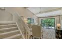 Bright living room featuring high ceilings, comfortable seating, and sliding glass doors to the outside at 1610 Treehouse Cir # T130, Sarasota, FL 34231