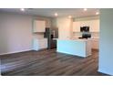 Modern kitchen with white cabinets, stainless steel appliances, and a central island at 17060 James Trl, Parrish, FL 34219