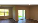 Bright living room with sliding glass doors that fill the space with natural light at 17060 James Trl, Parrish, FL 34219