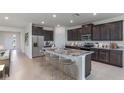 Spacious kitchen with stainless steel appliances and a large center island with seating at 17122 James Trl, Parrish, FL 34219