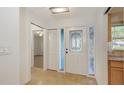 Bright foyer with decorative glass door and tiled flooring at 2261 Linwood Dr, Sarasota, FL 34232