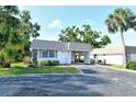 Charming single-story home featuring a well-kept lawn, covered carport, and mature landscaping at 2332 Canalbluff Pl # 298, Sarasota, FL 34231