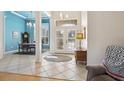 Bright foyer with tile flooring leading to an elegant dining room and french doors to the lanai at 2439 Sonoma W Dr, Nokomis, FL 34275