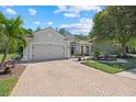 Charming single-story home with brick paver driveway and a well-manicured front yard at 259 Golden Harbour Trl, Bradenton, FL 34212