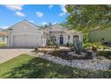 Charming single-story home with a well-manicured lawn and a welcoming blue front door at 259 Golden Harbour Trl, Bradenton, FL 34212