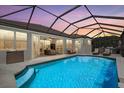 Inviting screened-in pool area with ample seating for relaxing and entertaining at 259 Golden Harbour Trl, Bradenton, FL 34212