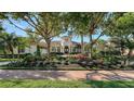 Beautiful home showcasing a tile roof, tower entry, and meticulously maintained landscaping at 3153 Founders Club Dr, Sarasota, FL 34240