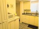 Cozy kitchen features white cabinetry, neutral countertops, and essential appliances for convenient meal preparation at 3719 Lake Bayshore Dr # H-204, Bradenton, FL 34205