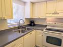 Efficient kitchen space features a stainless steel sink, white appliances, and practical layout for easy cooking at 3719 Lake Bayshore Dr # H-204, Bradenton, FL 34205