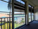 Relaxing enclosed porch overlooking the pool and lake with ample windows to enjoy the scenery at 3719 Lake Bayshore Dr # H-204, Bradenton, FL 34205