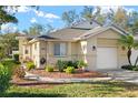 Charming single-story home with a well-manicured lawn, a two-car garage and beautiful landscaping in a warm-toned color palette at 411 28 W St, Palmetto, FL 34221