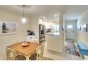 Bright dining area adjacent to a modern kitchen with stainless steel appliances at 4307 Gulf Dr # 202, Holmes Beach, FL 34217