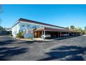 Exterior view of building with covered parking at 4307 Gulf Dr # 202, Holmes Beach, FL 34217
