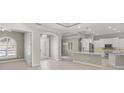 Spacious living room featuring tile floors, arched doorway, open concept kitchen, and neutral paint at 5354 Nathaniel Pl, Sarasota, FL 34233