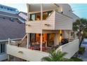 Multi-level rear exterior featuring balconies, outdoor dining and spiral staircase at 540 Beach Rd # 510, Sarasota, FL 34242