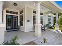 Inviting front porch showcasing a cozy porch swing, elegant columns, and stylish details, enhancing the home's curb appeal at 541 Fore Dr, Bradenton, FL 34208